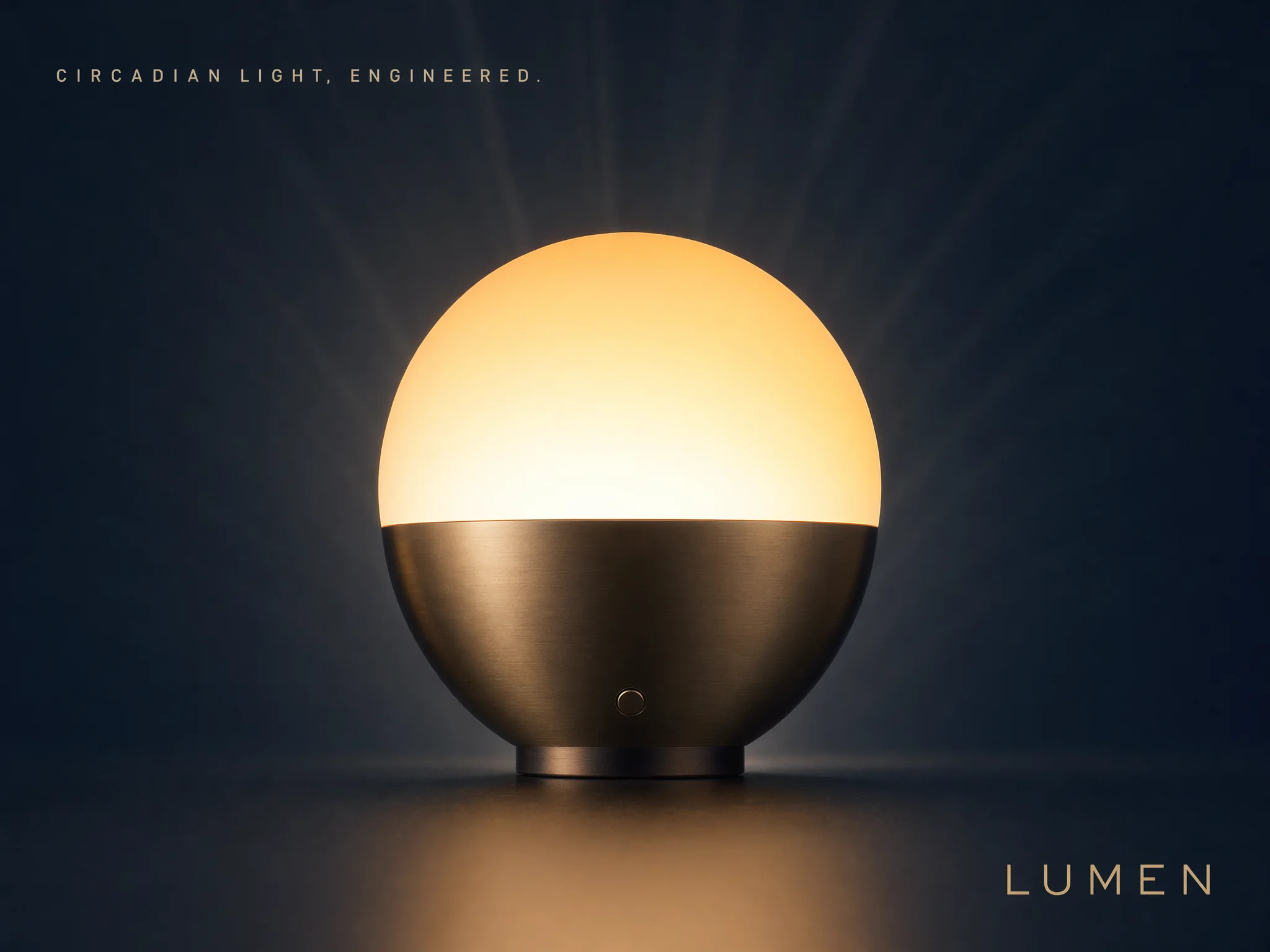 Lumen feature card — brushed bronze orb lamp on navy backdrop with typography
